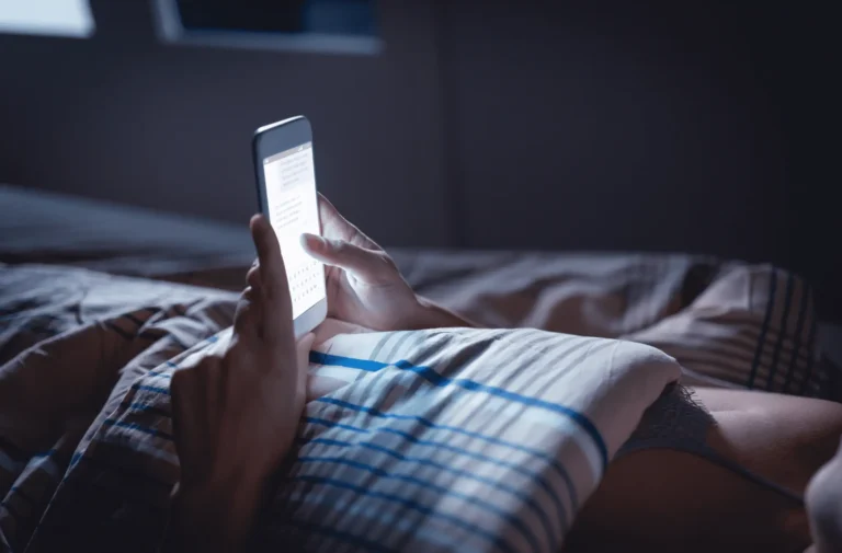 Comfortable night scene with a person using a smartphone.