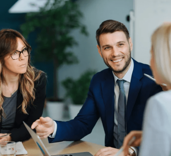 Engaging workplace conversation among professionals in a modern office.